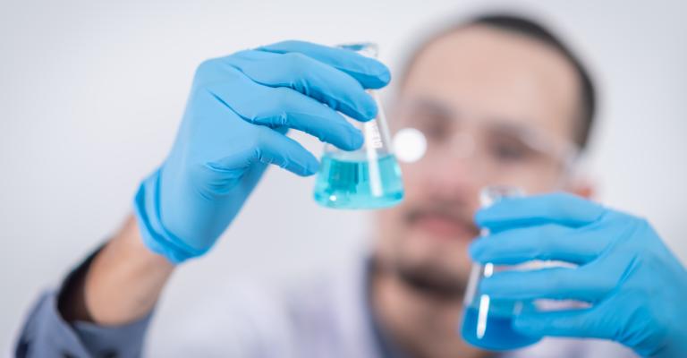 person-holding-glass-flasks